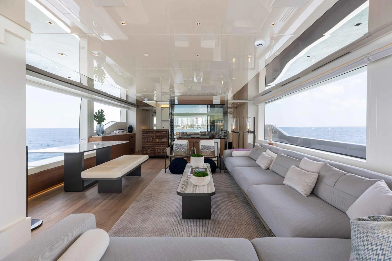 The spacious salon features modern furnishings and expansive windows offering stunning ocean views. aboard CHAMELEON Yacht for Sale