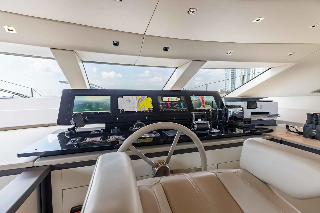 The helm station features advanced navigation equipment and luxurious seating, offering a commanding view for the captain. aboard CHAMELEON Yacht for Sale