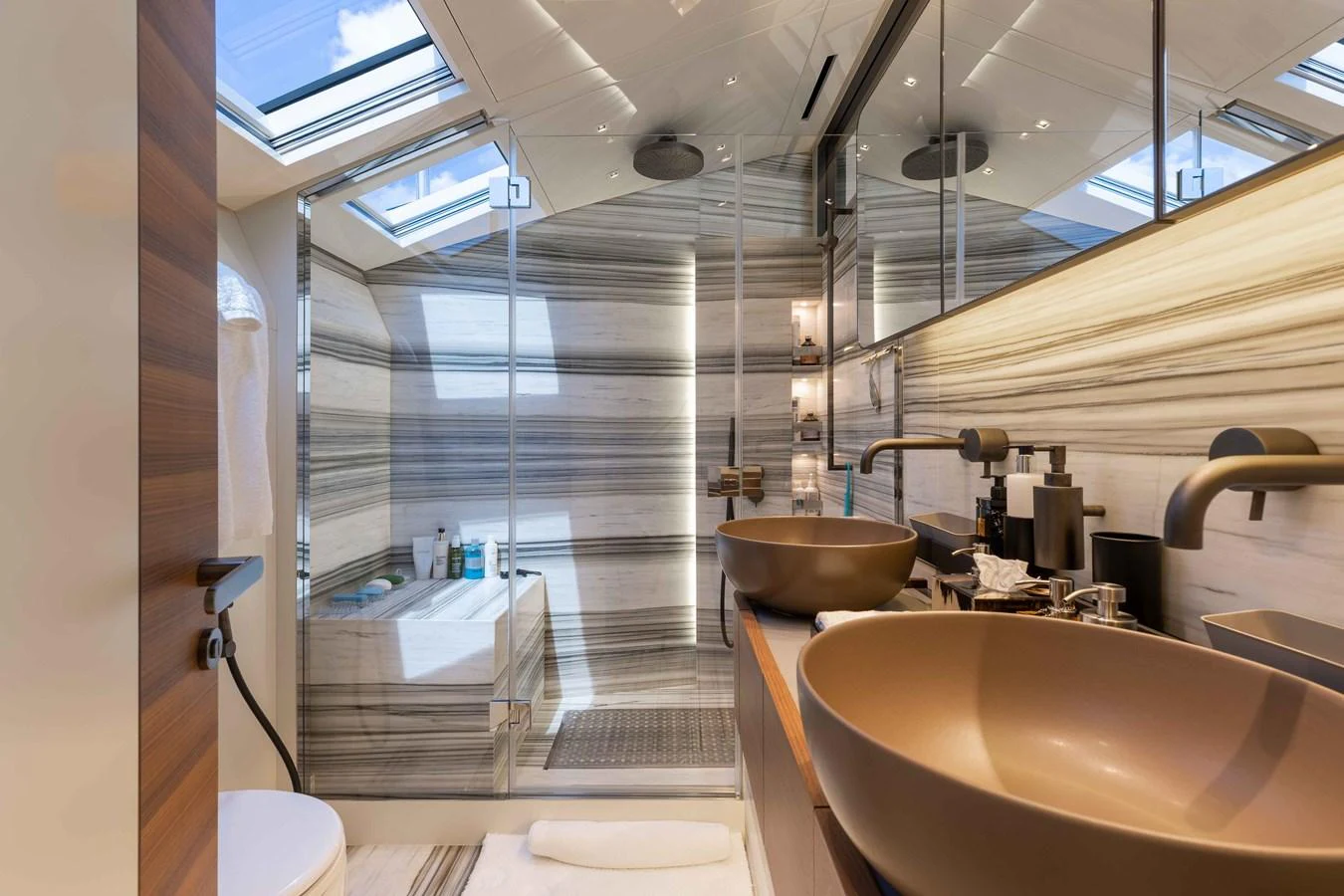 The yacht's bathroom features a luxurious design with modern fixtures and ample natural light. aboard CHAMELEON Yacht for Sale