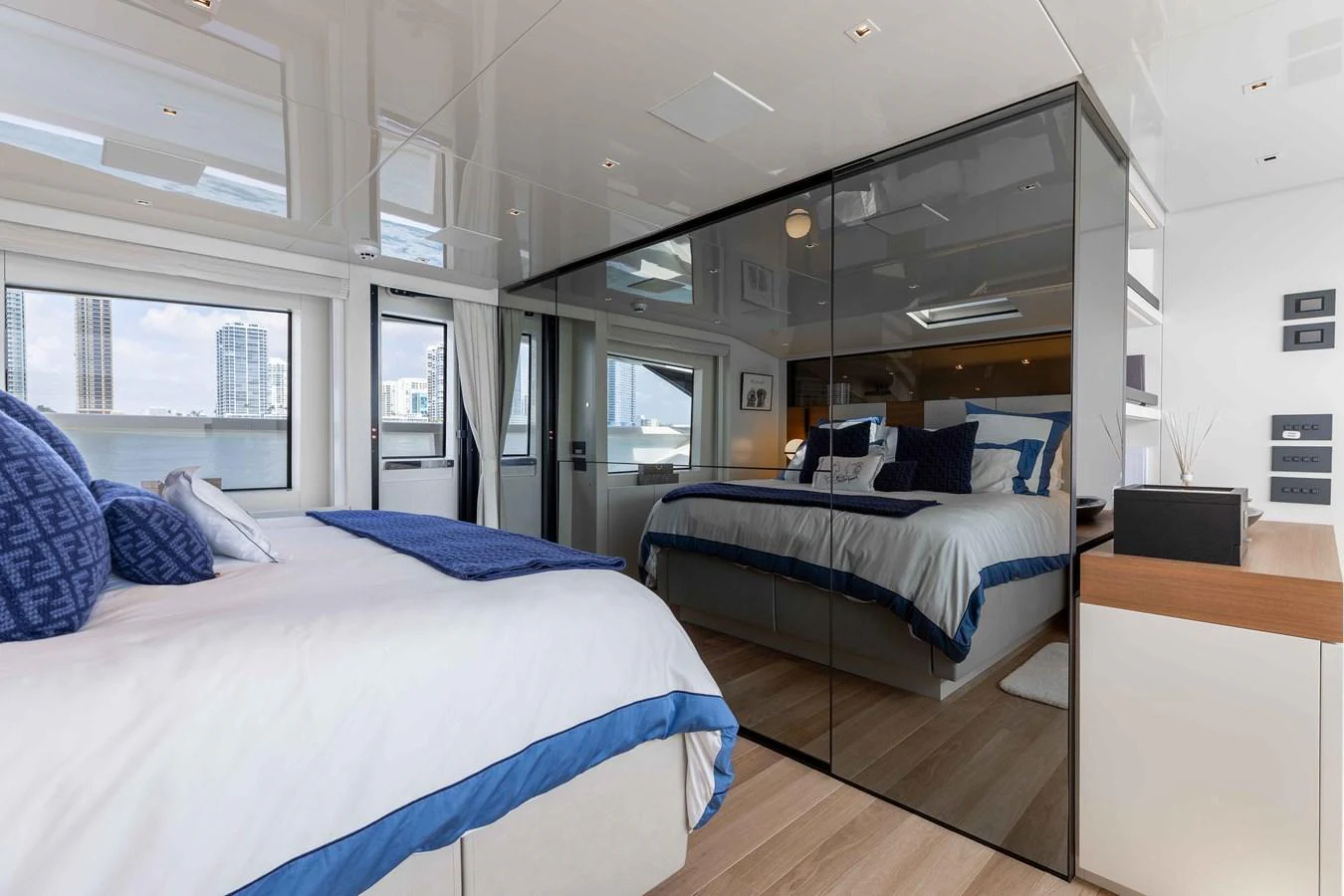 A luxurious stateroom with modern decor and large windows offering stunning views. aboard CHAMELEON Yacht for Sale