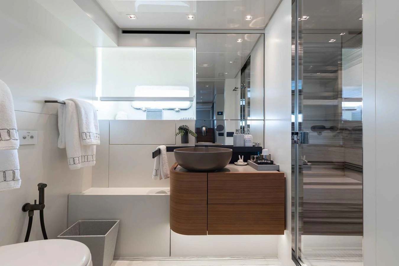 A modern yacht bathroom with sleek fixtures and ample lighting. aboard CHAMELEON Yacht for Sale