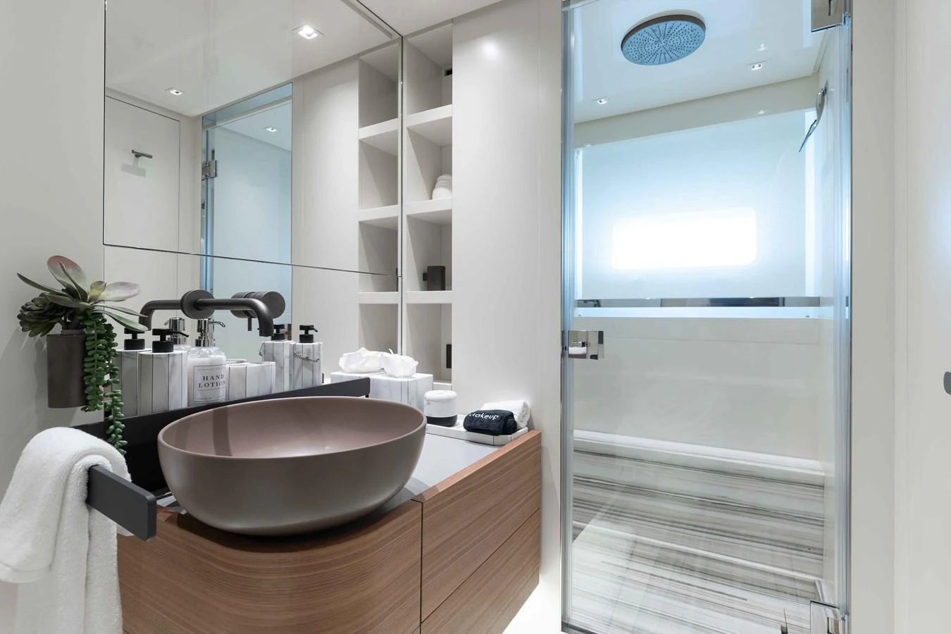 A modern and elegant yacht bathroom with sleek fixtures and ample lighting. aboard CHAMELEON Yacht for Sale