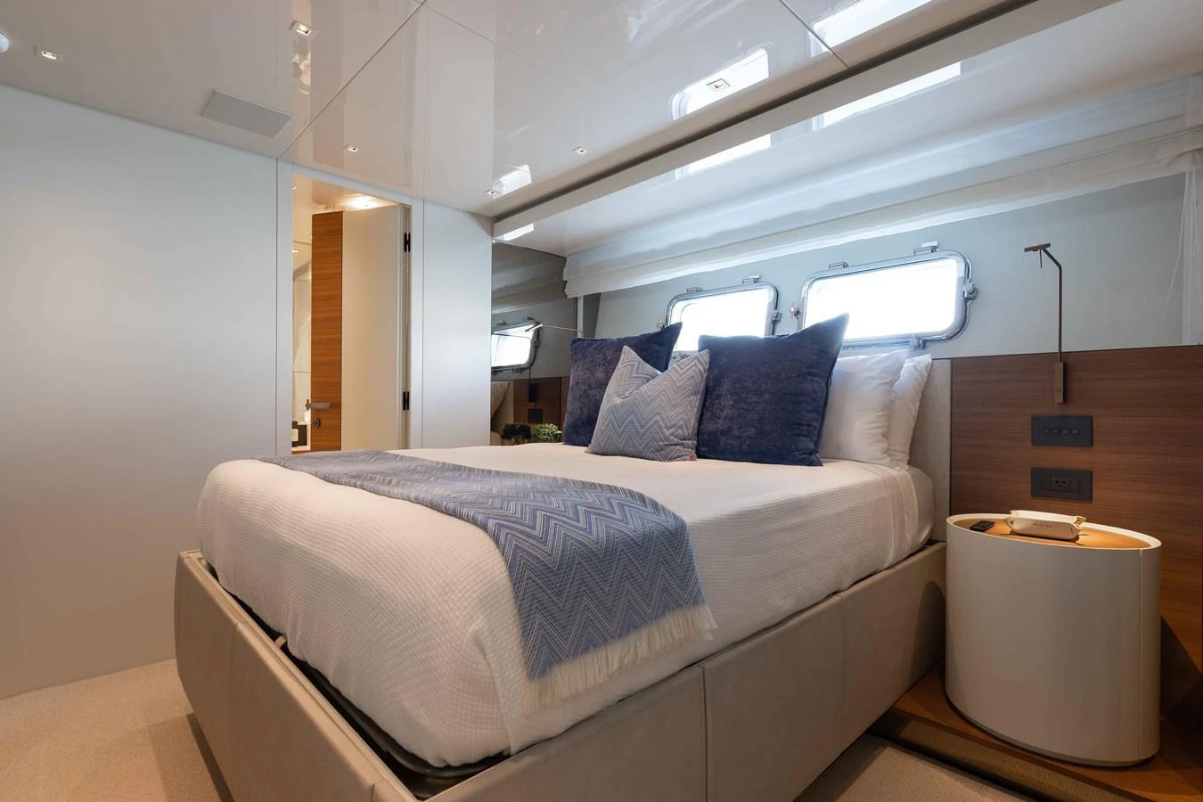 The stateroom features a plush bed with elegant linens and ample natural light from the windows. aboard CHAMELEON Yacht for Sale
