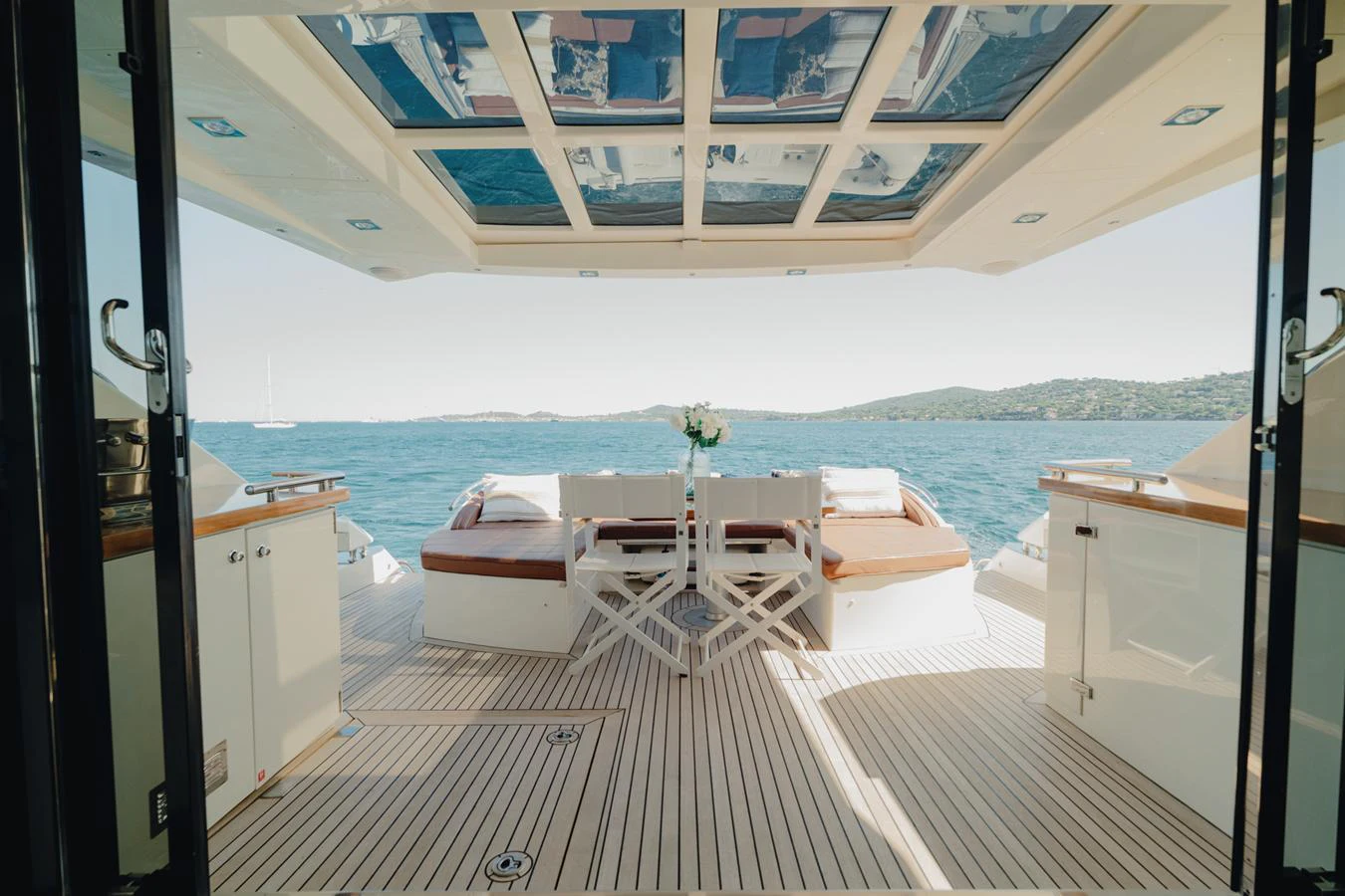 a room with a table chairs and a large body of water aboard SCUDERIA Yacht for Sale