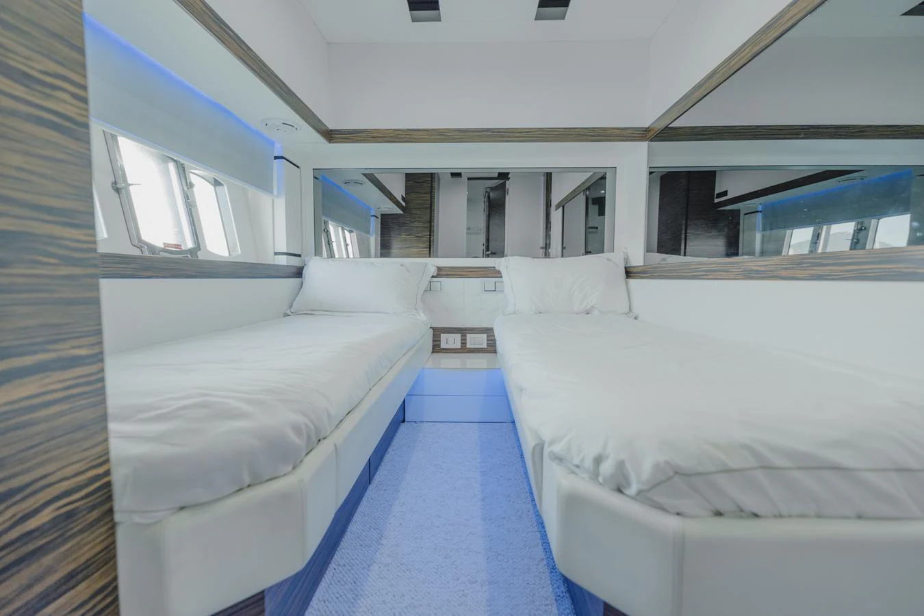 a room with beds and a window aboard SCUDERIA Yacht for Sale