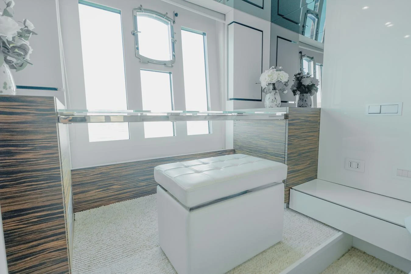 a room with a white couch and a large window aboard SCUDERIA Yacht for Sale