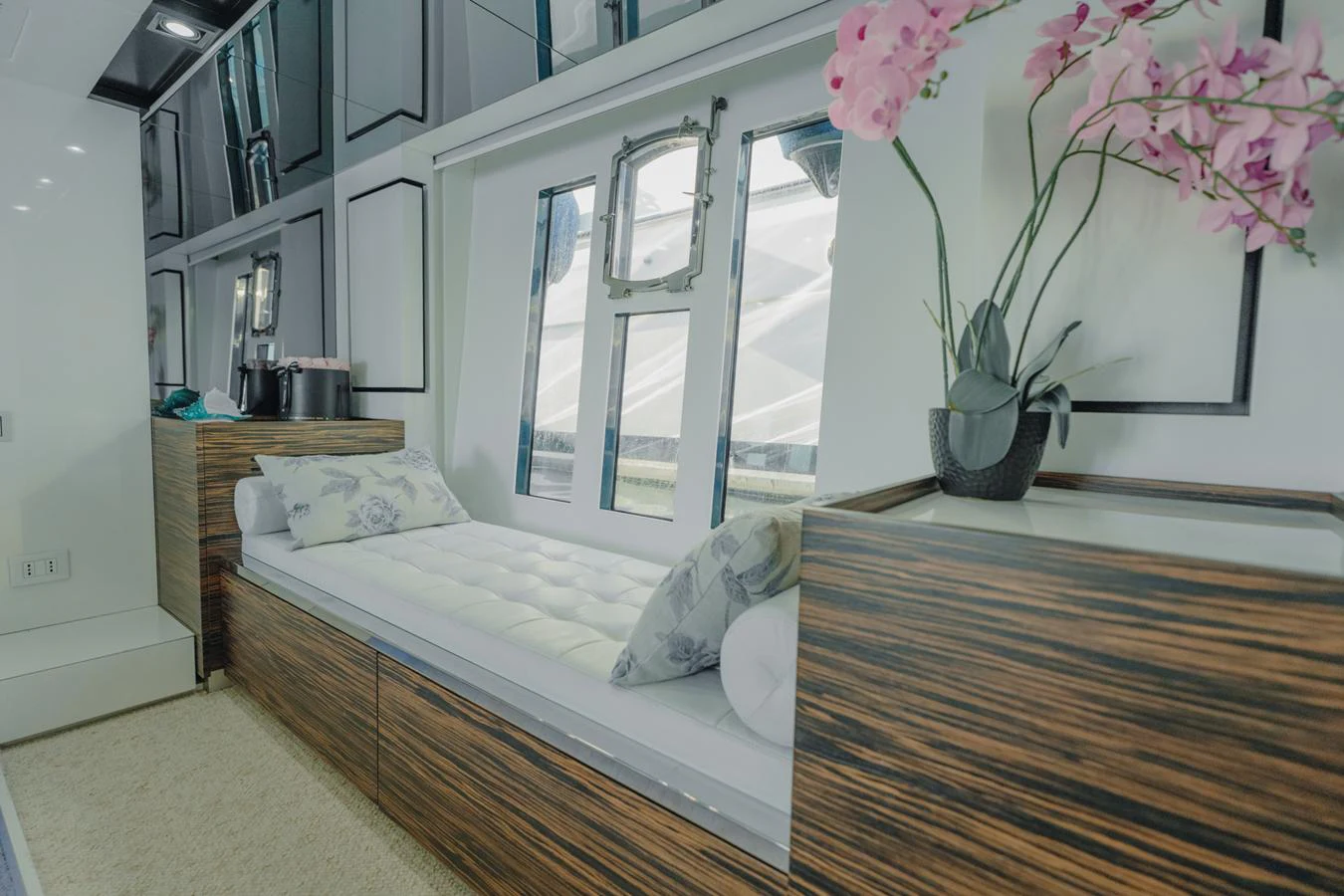 a bed with a flowered pillow aboard SCUDERIA Yacht for Sale