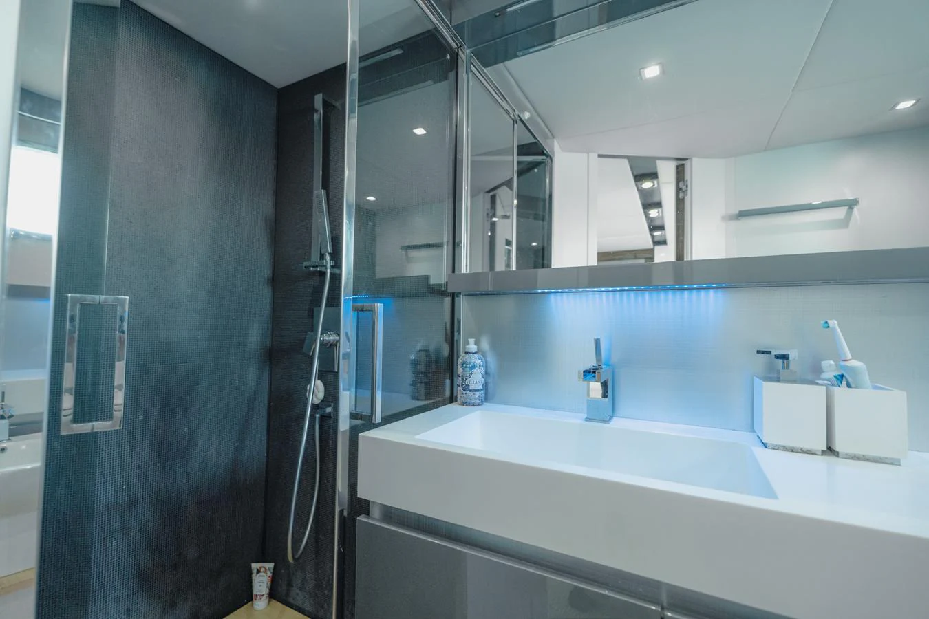 a bathroom with a sink and a mirror aboard SCUDERIA Yacht for Sale