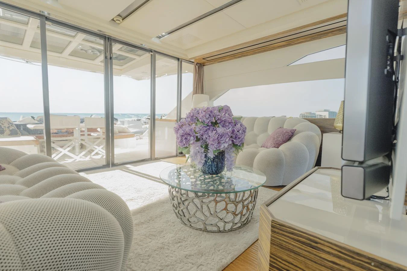 a living room with a large window aboard SCUDERIA Yacht for Sale
