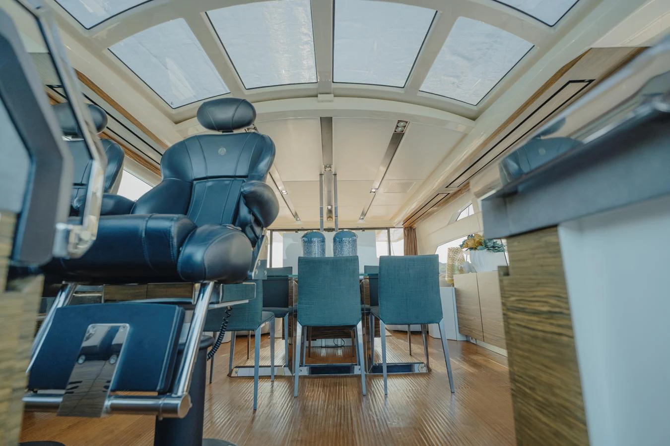a room with chairs and a table aboard SCUDERIA Yacht for Sale
