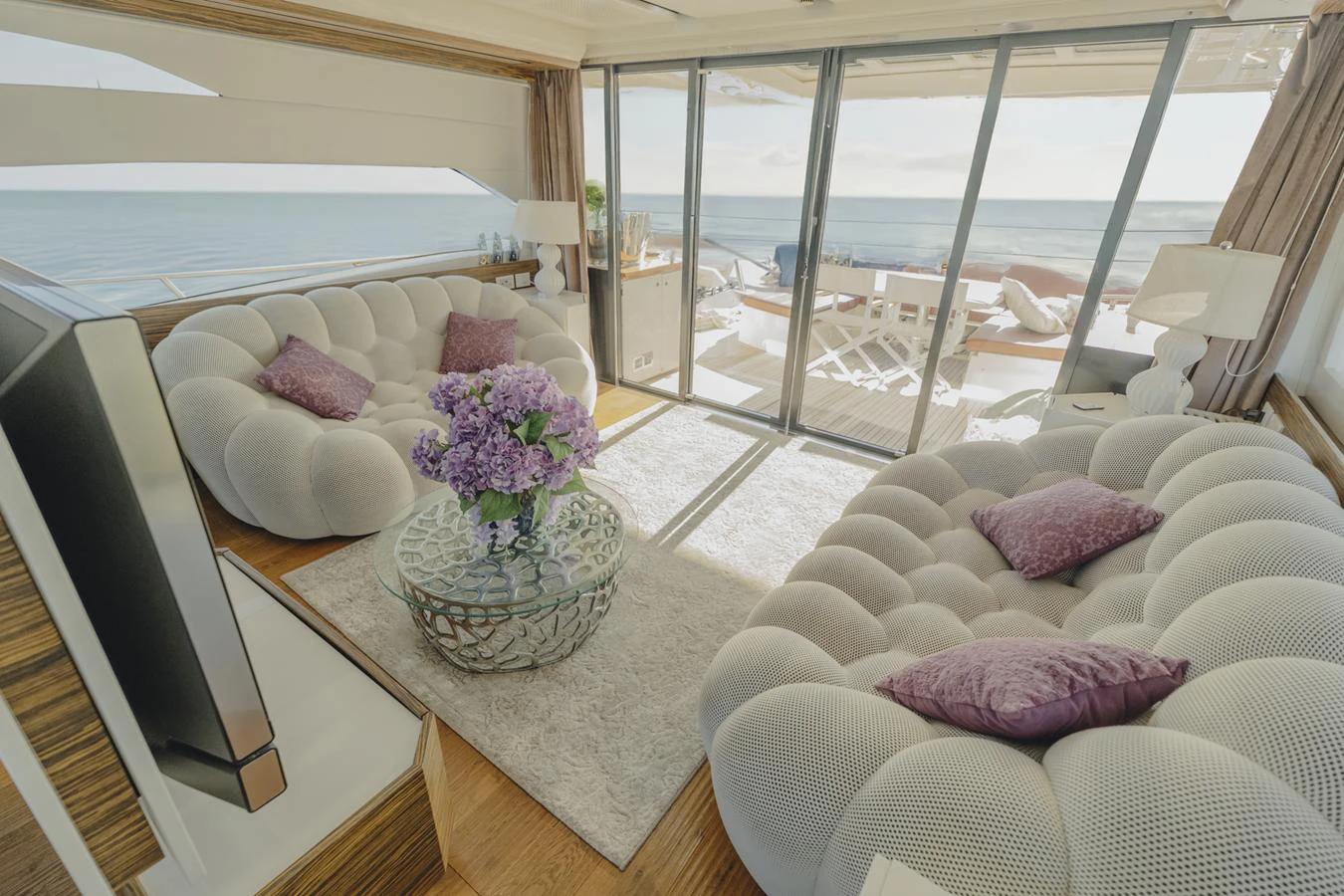 a living room with a large glass door aboard SCUDERIA Yacht for Sale