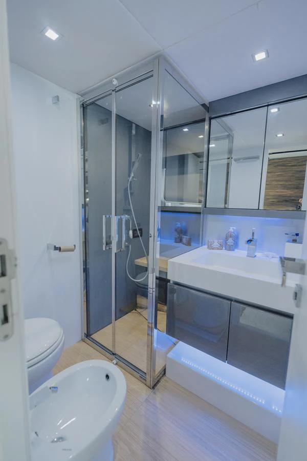 a bathroom with a glass shower aboard SCUDERIA Yacht for Sale