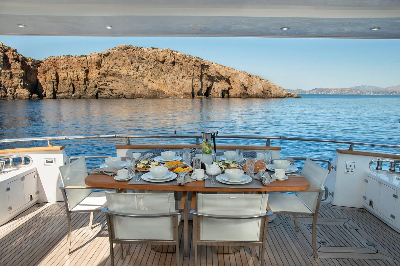 a table set for a meal on a boat aboard EL PECADO Yacht for Sale