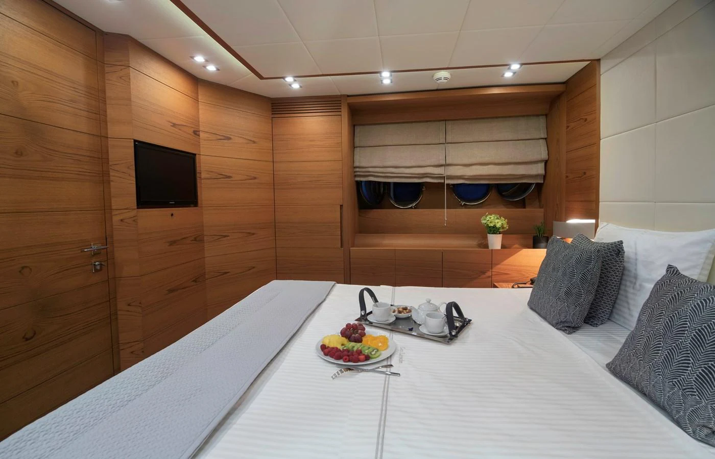 a room with a table and a bed aboard EL PECADO Yacht for Sale