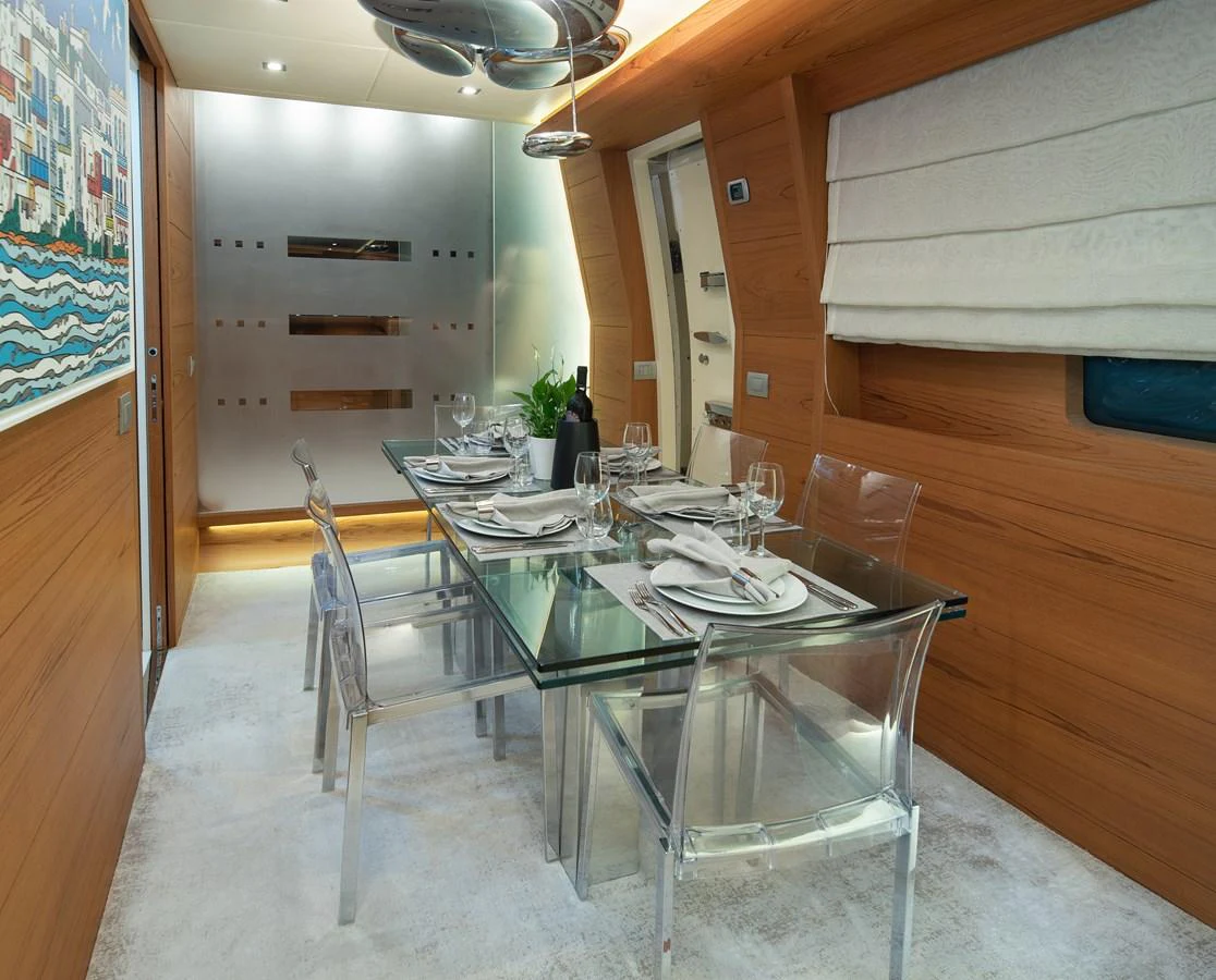 a dining table in a room aboard EL PECADO Yacht for Sale