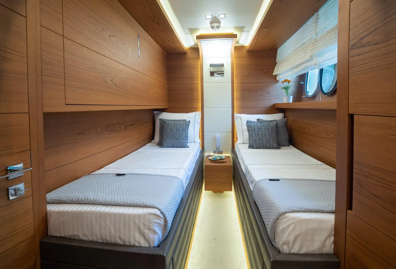 a room with two beds aboard EL PECADO Yacht for Sale