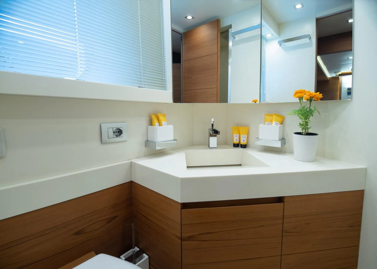 a bathroom with a sink and a mirror aboard EL PECADO Yacht for Sale