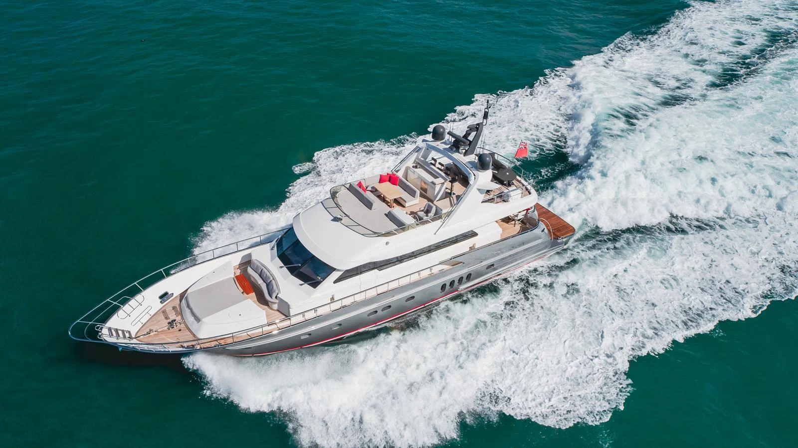 A sleek and modern yacht cruises swiftly through the open water, showcasing its elegant design and powerful performance. aboard TEST NAME Yacht for Sale