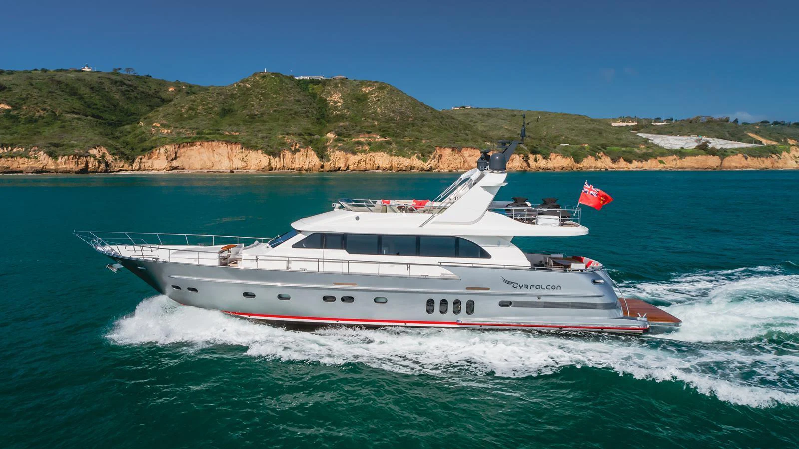 A sleek yacht cruises along the coastline, showcasing its elegant design and luxurious amenities. aboard TEST NAME Yacht for Sale