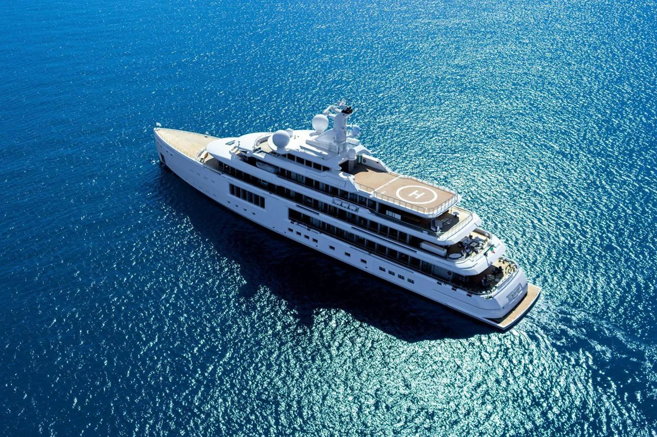 A luxurious yacht glides gracefully on the sparkling blue waters, showcasing its sleek design and spacious decks. aboard TEST NAME Yacht for Sale