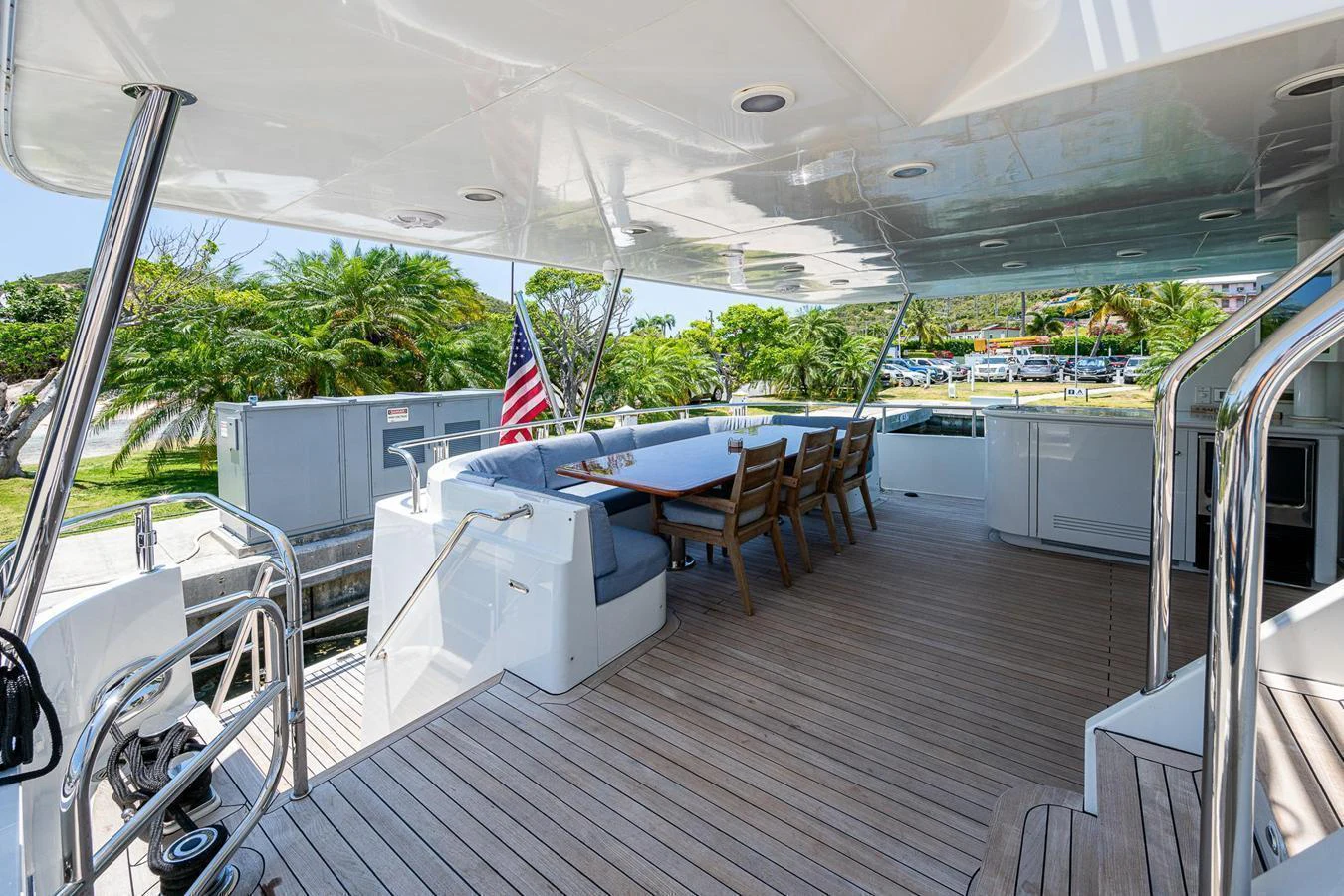 The aft deck features a spacious seating area with a dining table, perfect for alfresco dining and relaxation. aboard TEST NAME Yacht for Sale