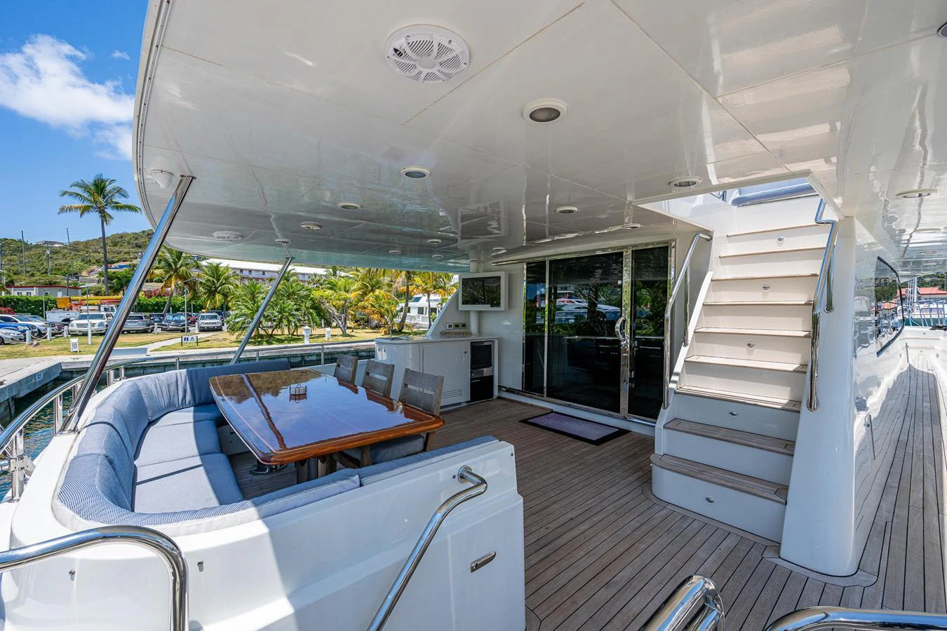 The aft deck features a spacious seating area with a dining table, perfect for alfresco meals and relaxation. aboard TEST NAME Yacht for Sale