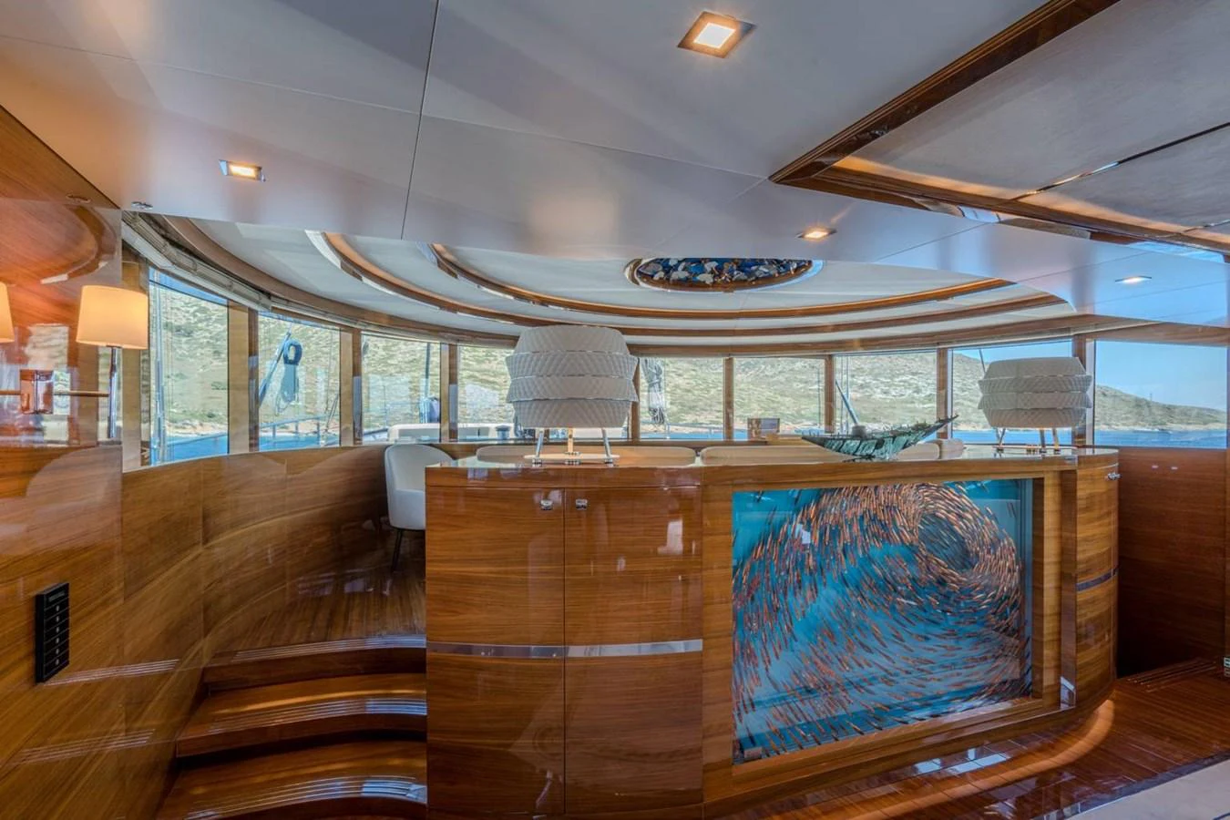 inside of a building with a large window and wood stairs aboard ATLANTIS PEARL Yacht for Sale