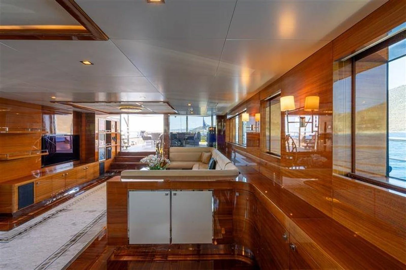 a room with a wood floor and a large window aboard ATLANTIS PEARL Yacht for Sale