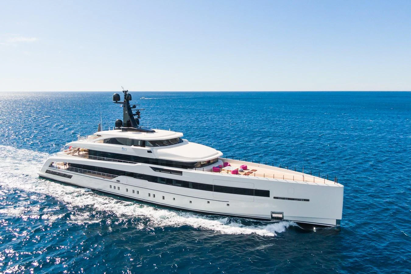 A sleek and modern yacht cruises through the open sea under a clear blue sky. aboard RIO Yacht for Sale