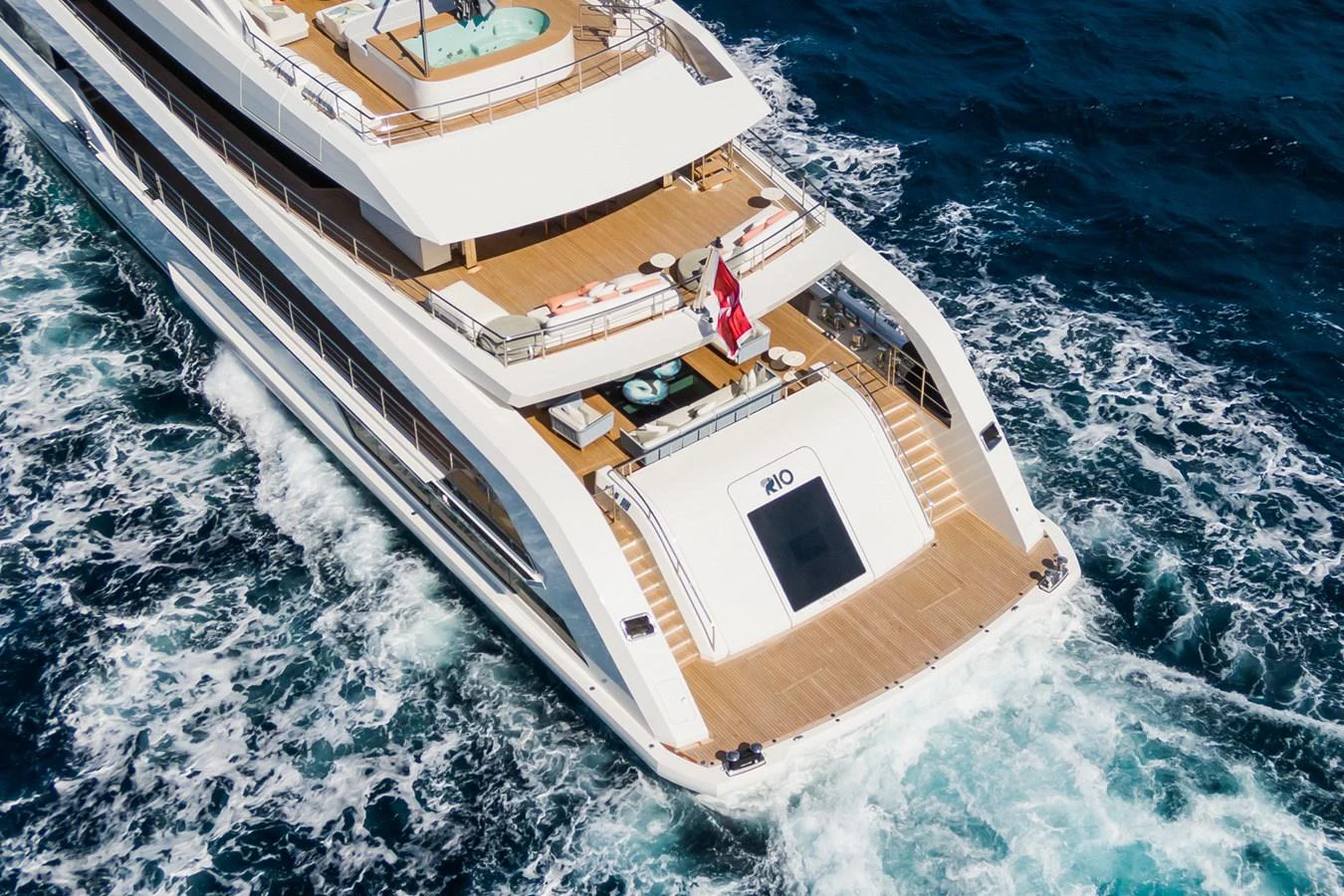 The yacht's aft deck features luxurious lounging areas and a jacuzzi, perfect for relaxation at sea. aboard RIO Yacht for Sale