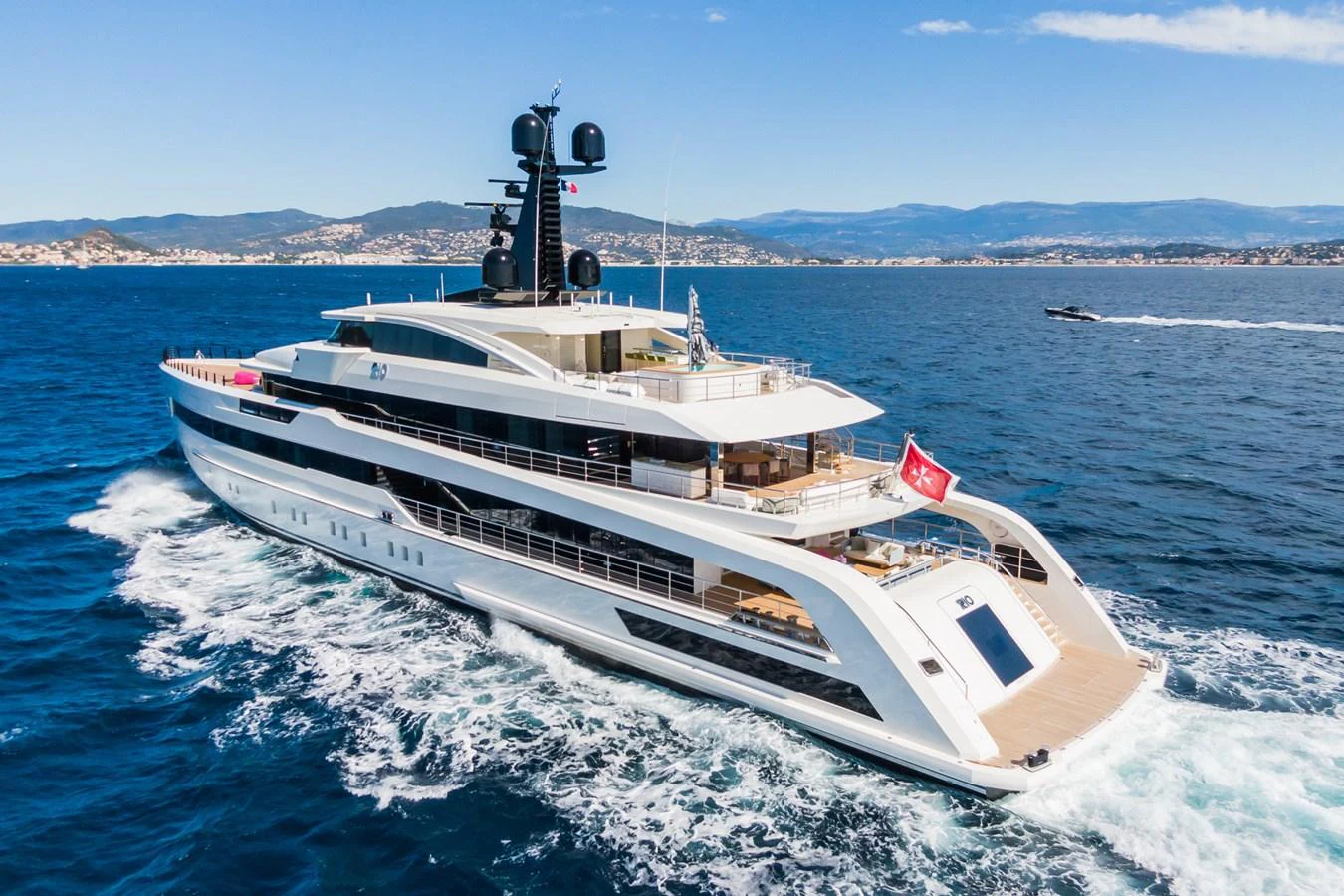 A luxurious yacht cruises through the open sea, showcasing its sleek design and spacious decks. aboard RIO Yacht for Sale