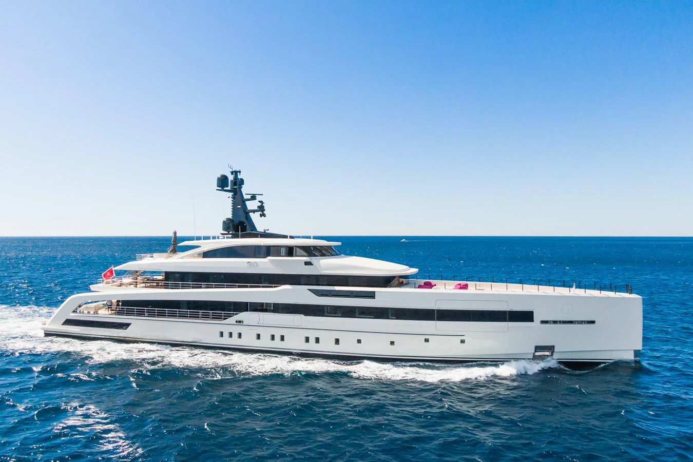 A sleek and modern yacht cruising on the open sea under a clear blue sky. aboard RIO Yacht for Sale