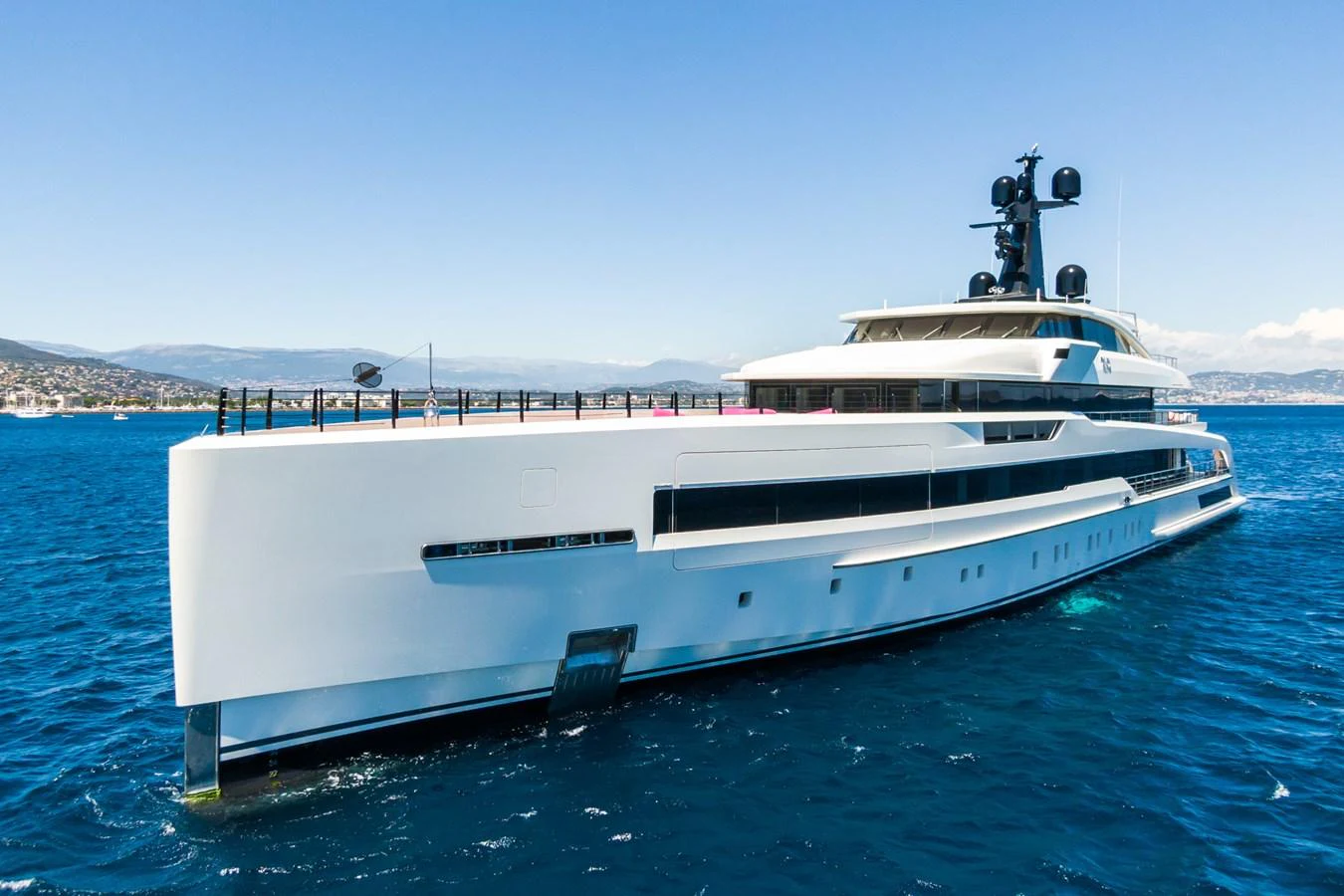 A sleek and modern yacht glides gracefully on the open water under a clear blue sky. aboard RIO Yacht for Sale