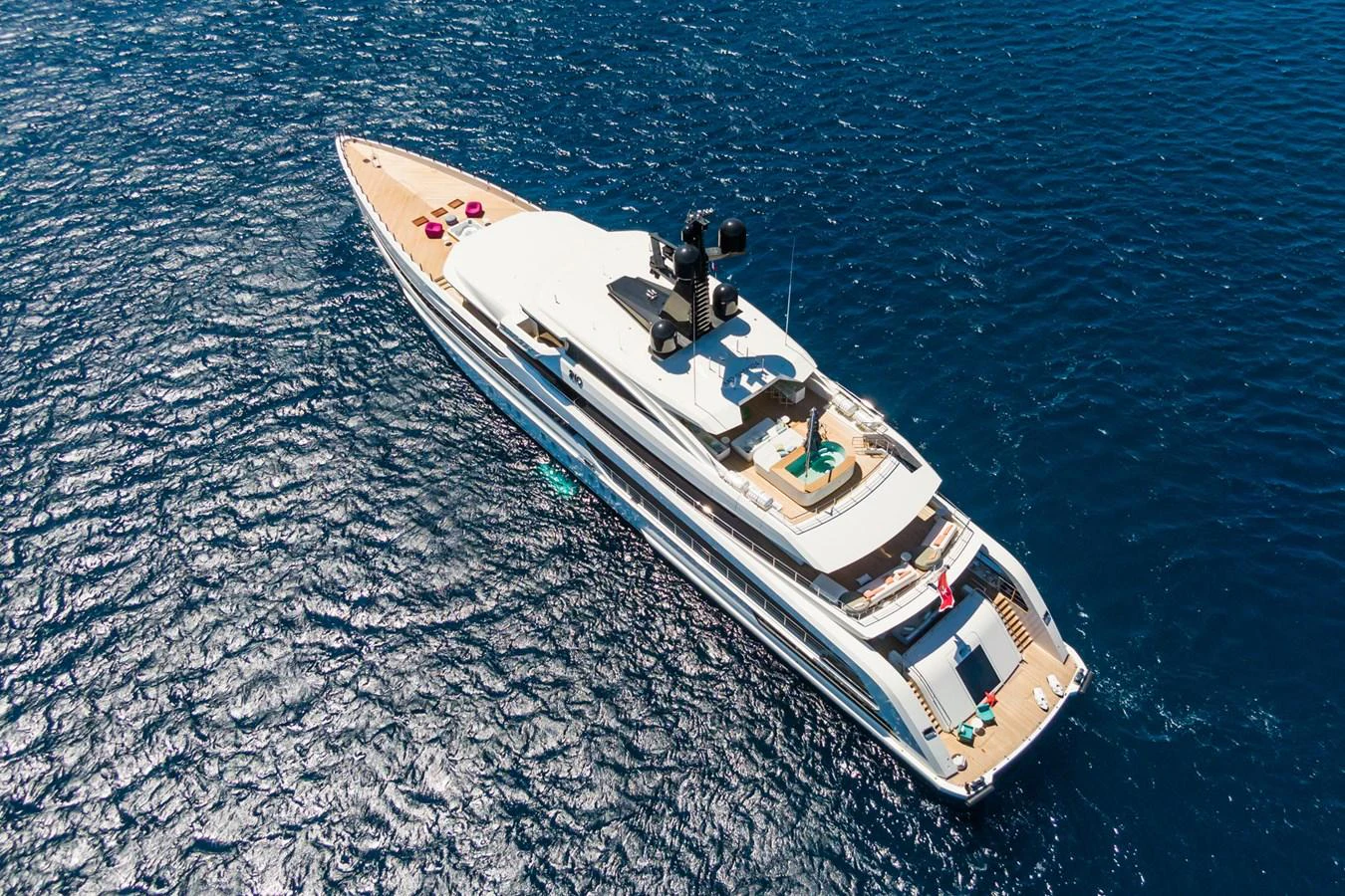 A luxurious yacht glides gracefully on the open sea, showcasing its sleek design and spacious decks. aboard RIO Yacht for Sale