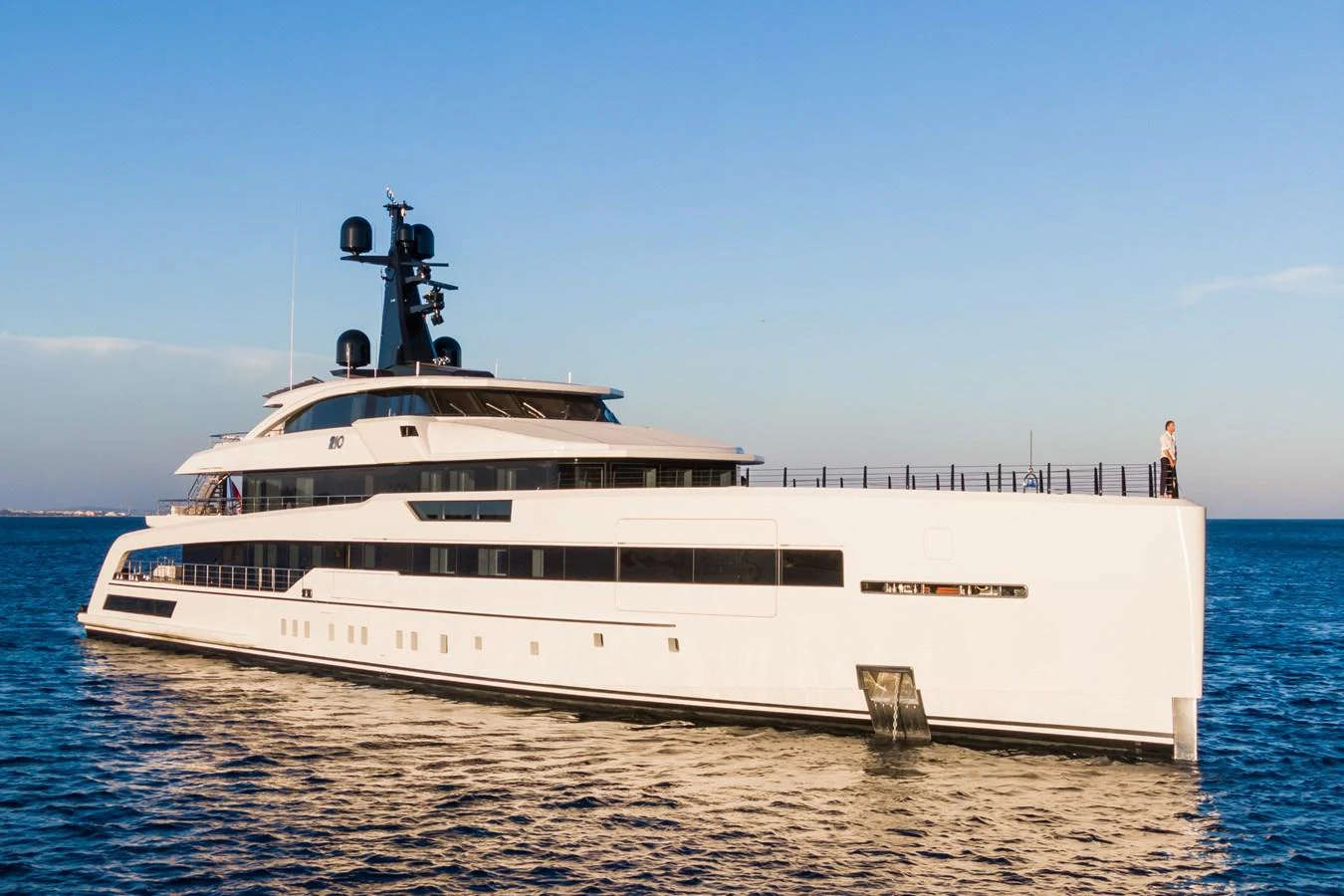 A sleek and modern yacht glides gracefully on the open water under a clear blue sky. aboard RIO Yacht for Sale