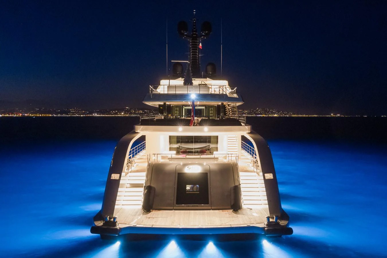 The yacht is beautifully illuminated at night, showcasing its elegant design and luxurious ambiance. aboard RIO Yacht for Sale