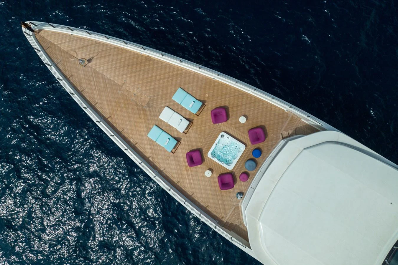 The foredeck features a luxurious jacuzzi surrounded by comfortable seating and sun loungers, perfect for relaxation. aboard RIO Yacht for Sale