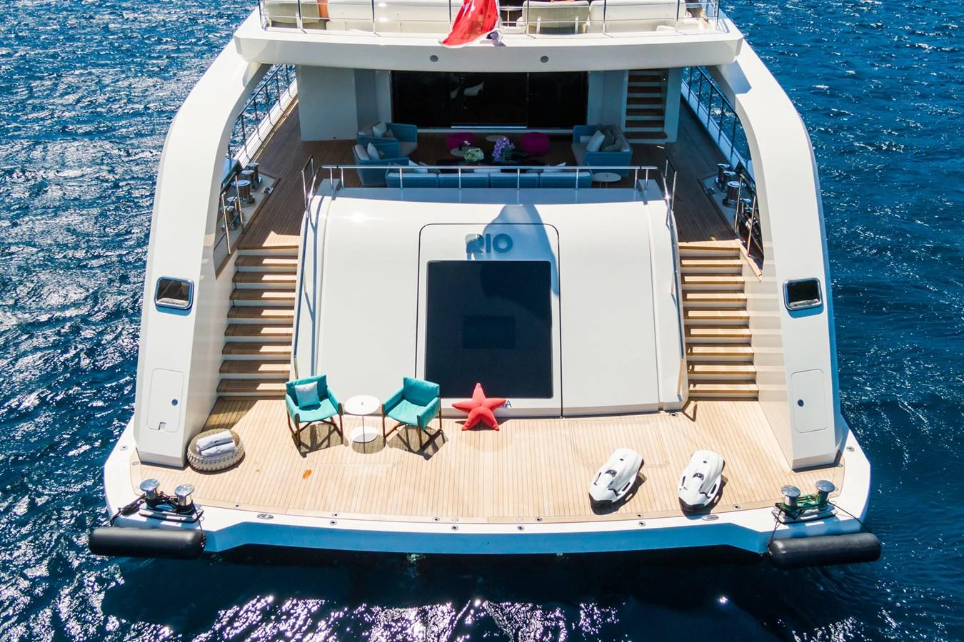 The aft deck of this yacht features a spacious lounging area with direct access to the water. aboard RIO Yacht for Sale