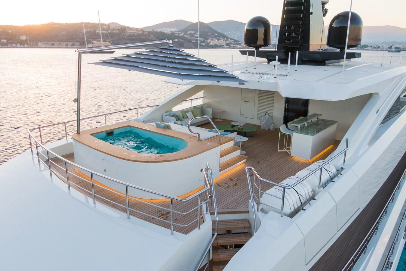 The yacht's aft deck features a luxurious hot tub and ample lounging space, perfect for relaxation and entertainment. aboard RIO Yacht for Sale