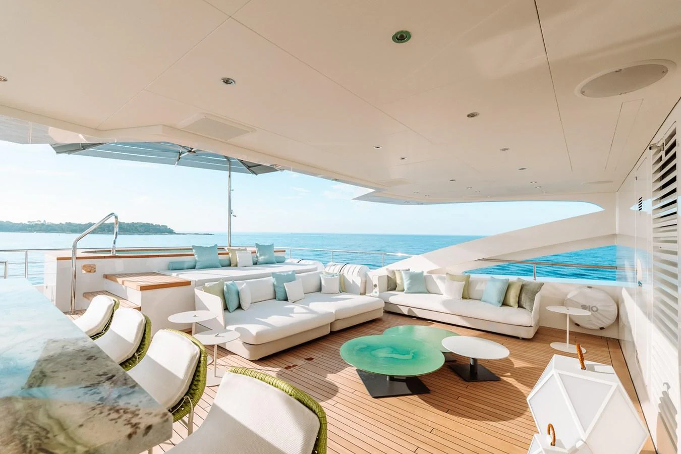 The aft deck features a spacious and elegant seating area with stunning ocean views. aboard RIO Yacht for Sale