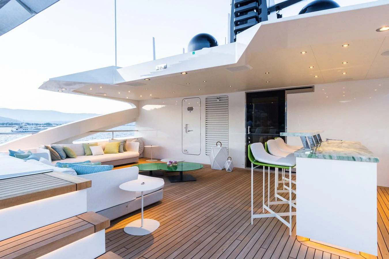 The aft deck features a stylish seating area and a sleek bar, perfect for entertaining guests. aboard RIO Yacht for Sale