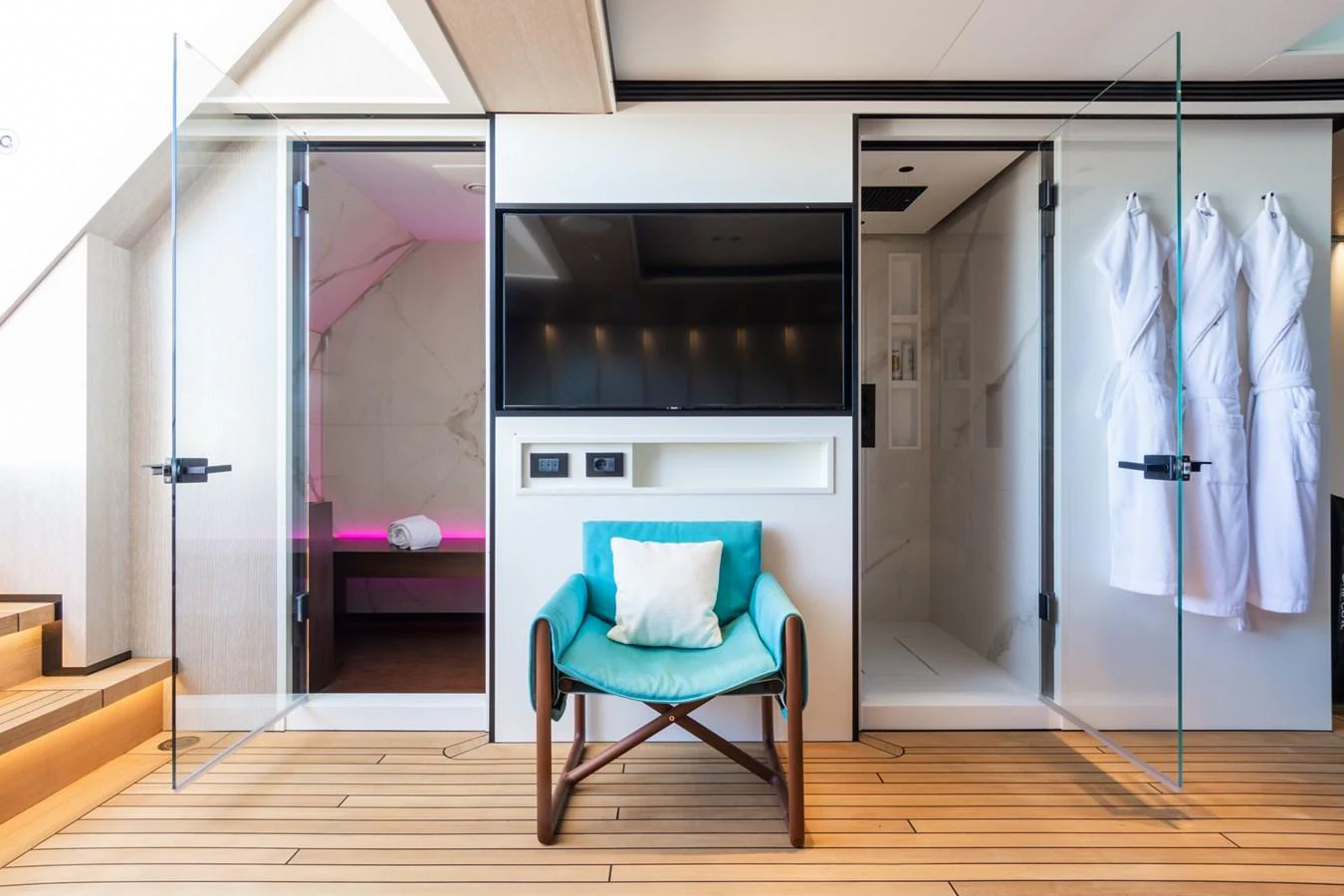 This stylish interior features a comfortable seating area with a modern design, adjacent to a luxurious bathroom and a cozy relaxation space. aboard RIO Yacht for Sale