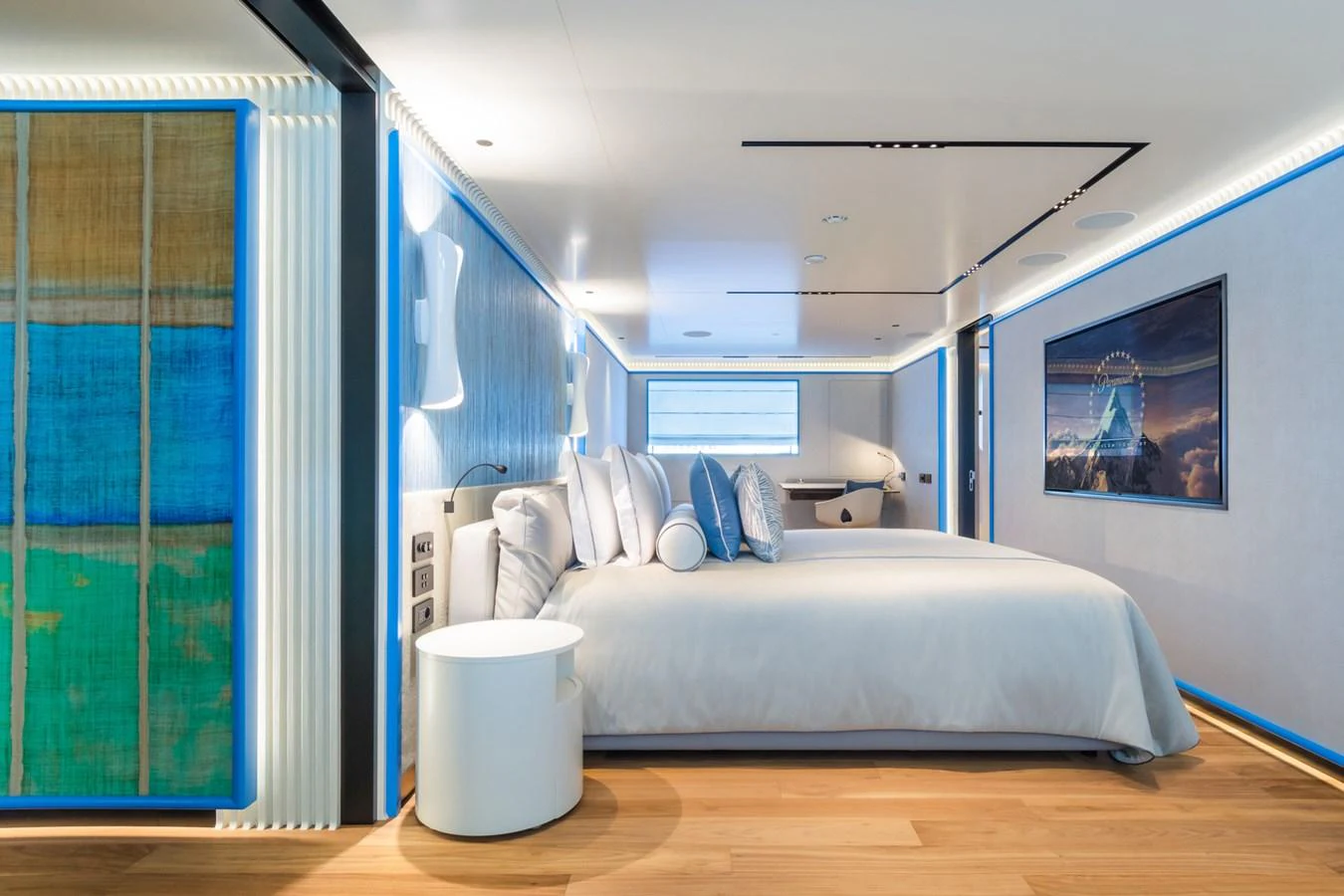 The master stateroom features a spacious bed, modern decor, and ambient lighting for a luxurious retreat. aboard RIO Yacht for Sale