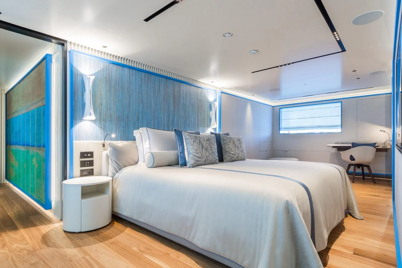 A luxurious stateroom featuring a large bed, modern decor, and ambient lighting. aboard RIO Yacht for Sale