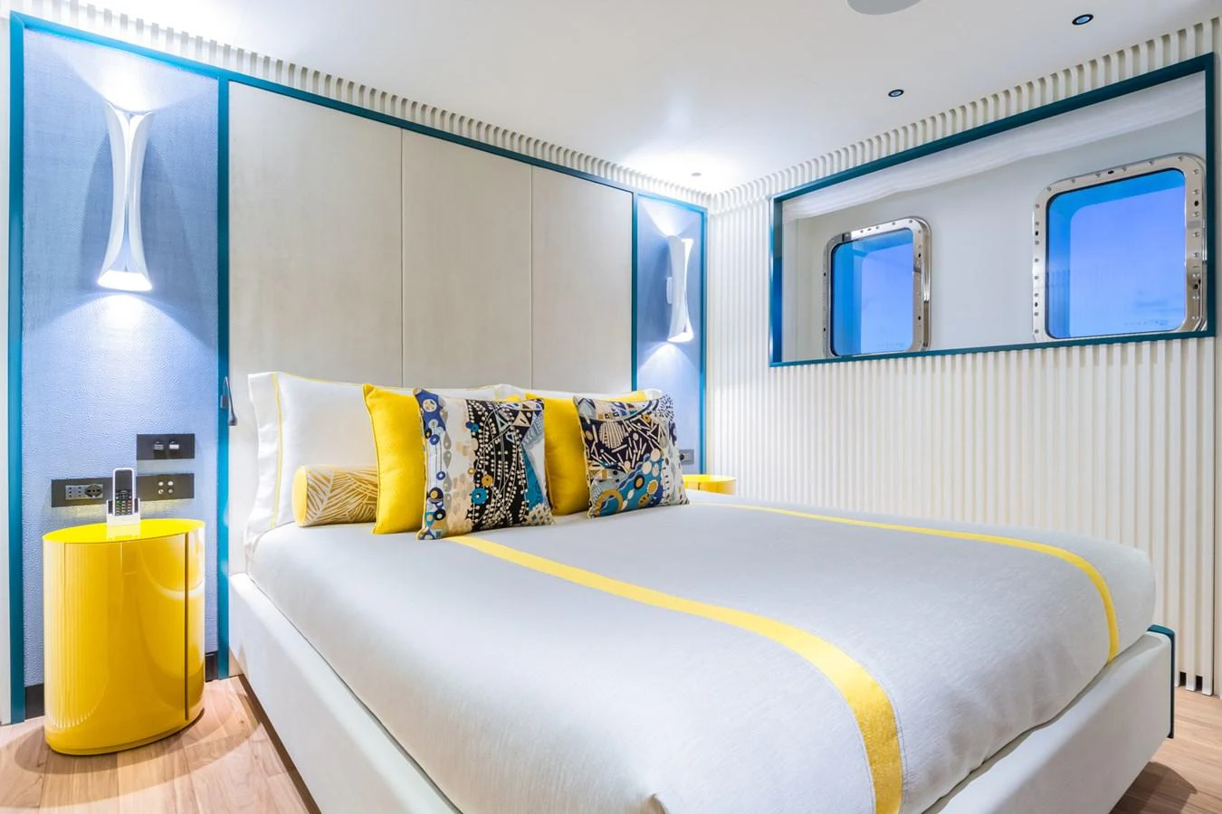 A luxurious stateroom with vibrant yellow accents and modern design elements. aboard RIO Yacht for Sale