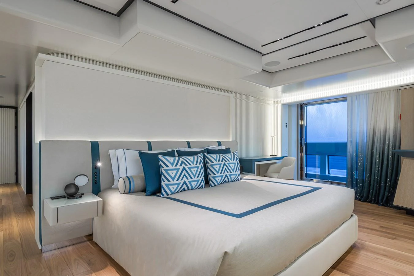 The master stateroom features a luxurious bed with elegant bedding and modern decor. aboard RIO Yacht for Sale