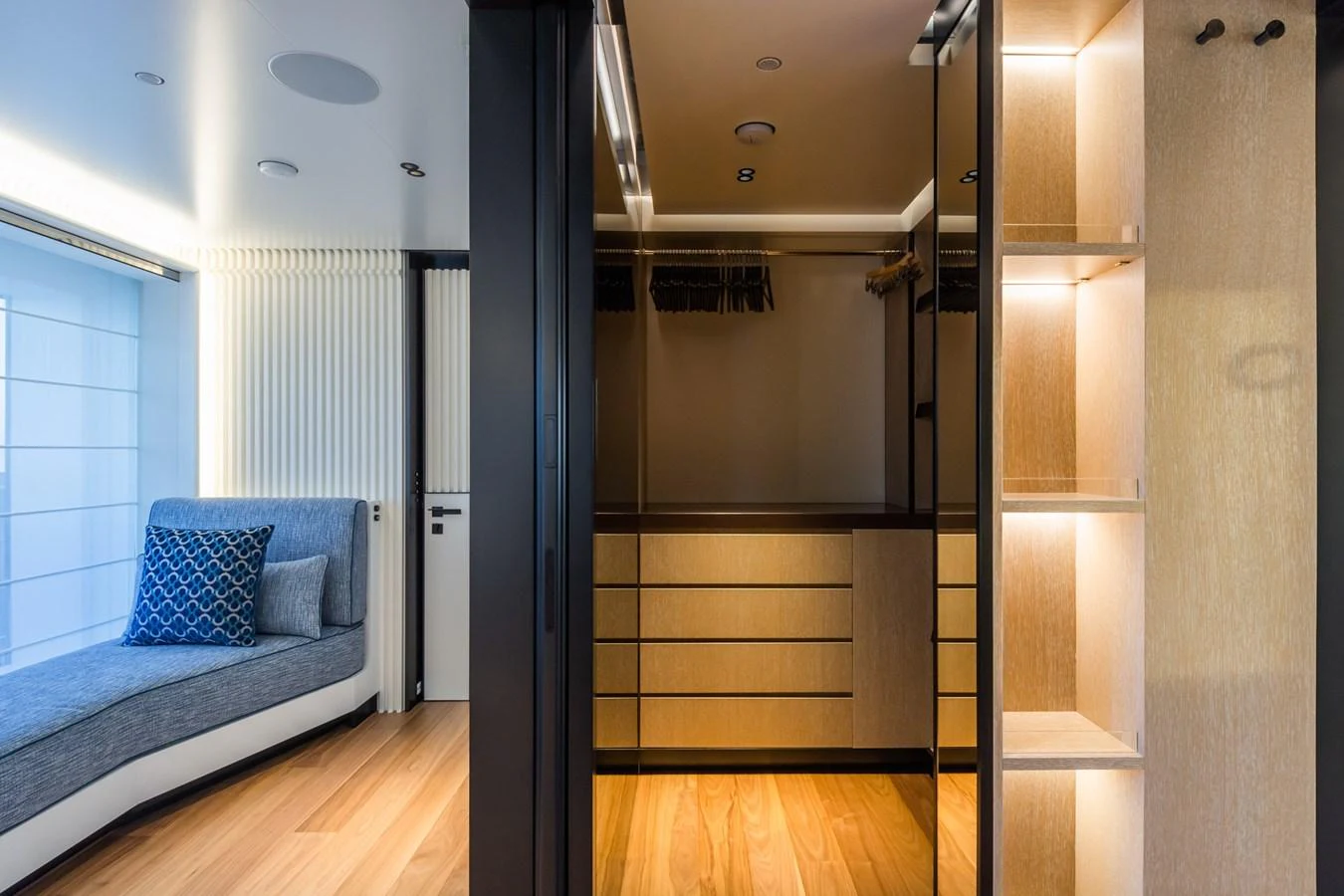 A luxurious yacht interior featuring a spacious closet area with ample storage and elegant lighting. aboard RIO Yacht for Sale