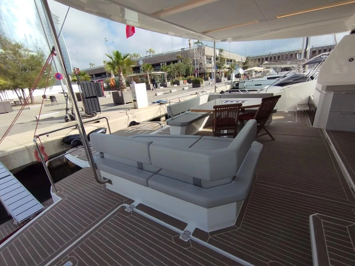 The aft deck features comfortable seating and a table, perfect for relaxing dockside. aboard LEOPARD 28M Yacht for Sale