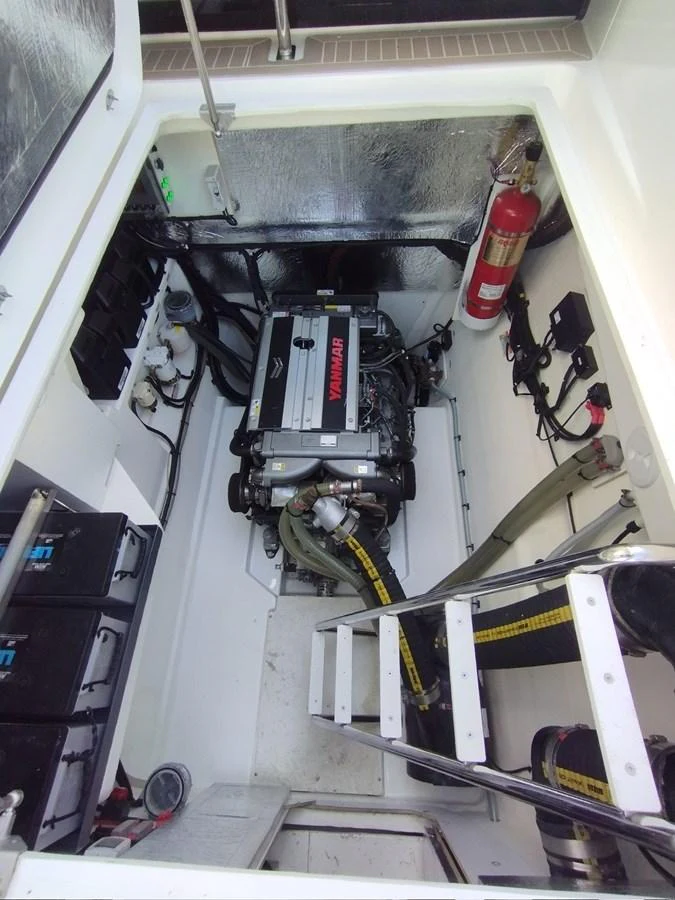 The image showcases the well-organized engine room of the yacht, featuring a prominently displayed engine and essential equipment. aboard LEOPARD 28M Yacht for Sale