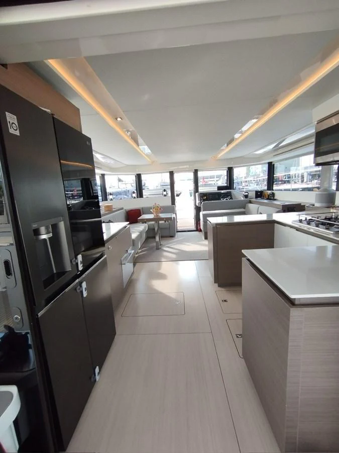 The yacht's galley features modern appliances and a sleek design, seamlessly connected to the salon area. aboard LEOPARD 28M Yacht for Sale
